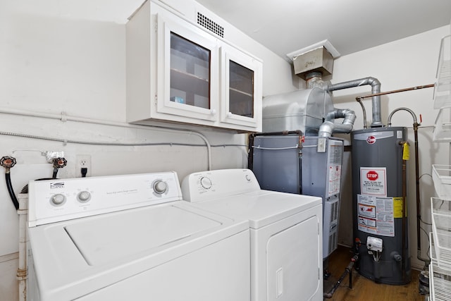 7957 Pine St, Taylor, MI 48180 - laundry room with washing machine and dryer, visible vents, water heater, wood finished floors, and laundry area