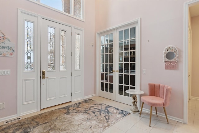 tiled foyer featuring french doors, baseboards, and visible vents