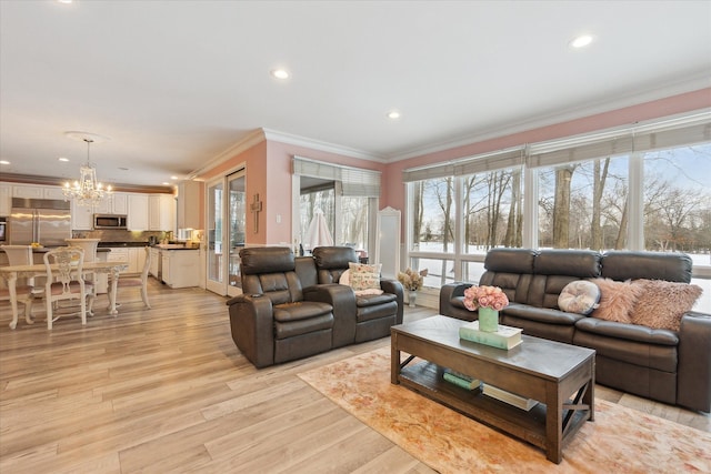 living area featuring a chandelier, recessed lighting, light wood finished floors, and ornamental molding