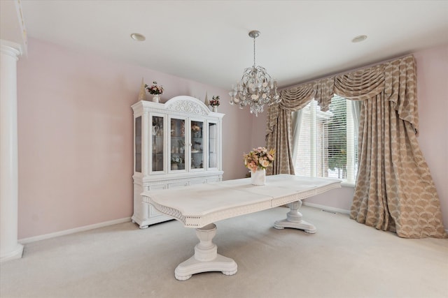 dining room featuring a chandelier, light carpet, and baseboards
