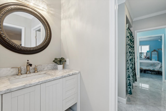 ensuite bathroom featuring connected bathroom, vanity, ornamental molding, marble finish floor, and baseboards