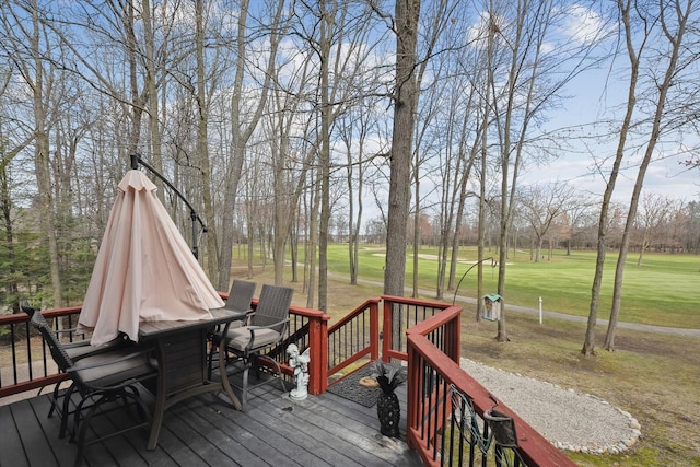 wooden deck featuring a yard