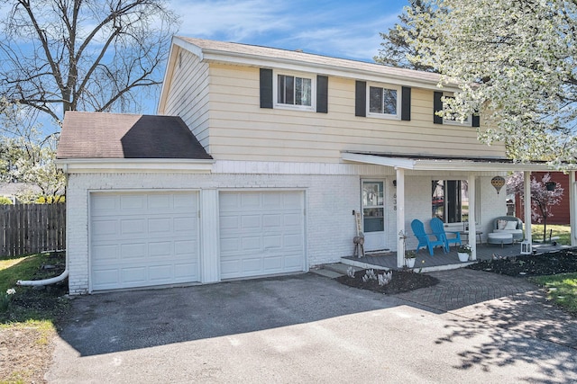 638 Franklin St, Linden, MI 48451 - view of front of house with brick siding, driveway, covered porch, and fence