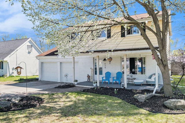 638 Franklin St, Linden, MI 48451 - view of front facade featuring covered porch, driveway, brick siding, and a garage