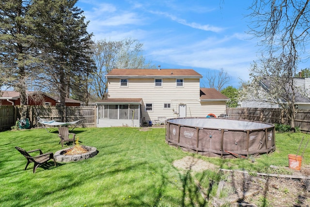 638 Franklin St, Linden, MI 48451 - back of house featuring a sunroom and a fire pit