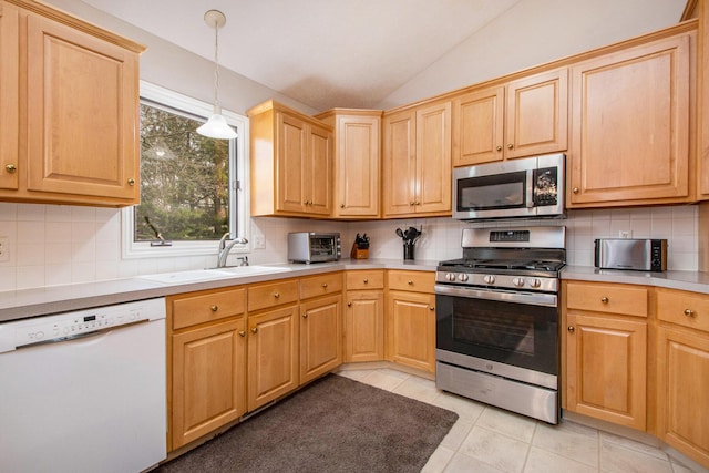 2511 Bowenton Pl SW, Wyoming, MI 49519 - kitchen featuring light tile patterned floors, stainless steel appliances, light countertops, a sink, and lofted ceiling