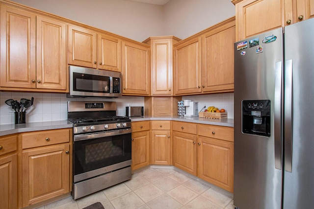 2511 Bowenton Pl SW, Wyoming, MI 49519 - kitchen with light tile patterned floors, backsplash, appliances with stainless steel finishes, and light countertops