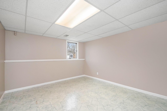 2511 Bowenton Pl SW, Wyoming, MI 49519 - below grade area with marble finish floor, visible vents, a paneled ceiling, and baseboards