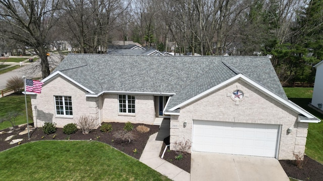 2511 Bowenton Pl SW, Wyoming, MI 49519 - view of front facade with driveway, a front yard, a shingled roof, and brick siding