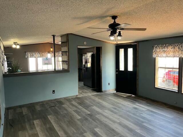 entrance foyer with wood finished floors, a textured ceiling, a ceiling fan, and lofted ceiling