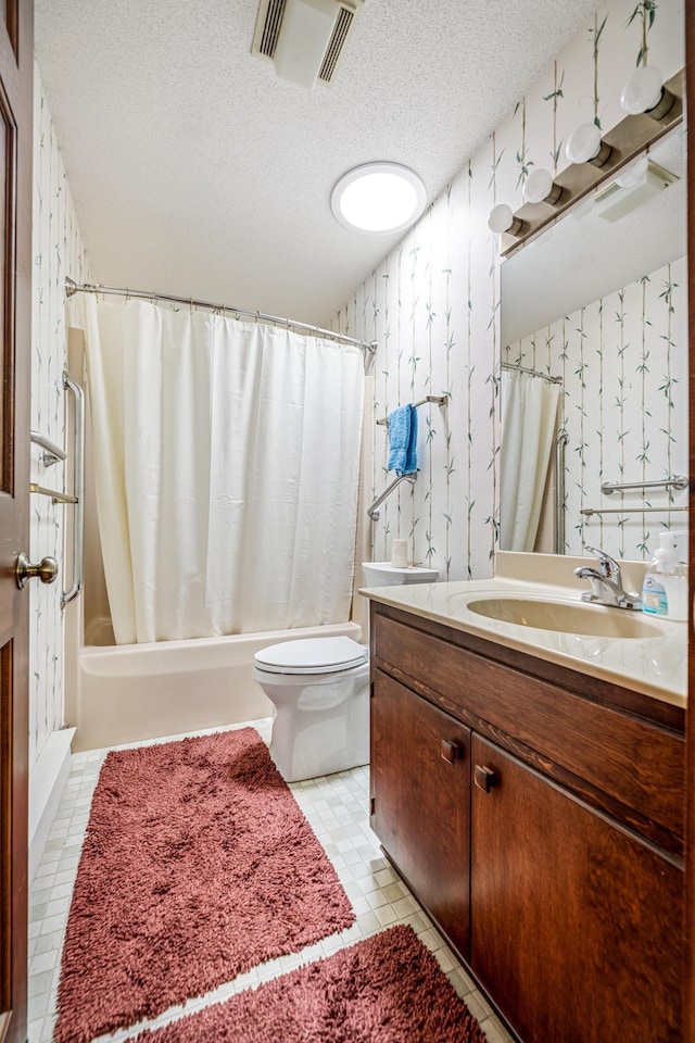 bathroom featuring a textured ceiling, vanity, visible vents, toilet, and shower / bath combo with shower curtain