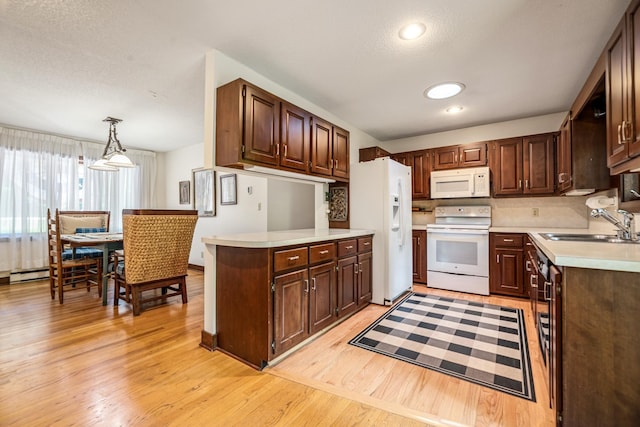 kitchen with light countertops, white appliances, a sink, and backsplash