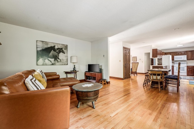 living room with light wood finished floors and baseboards