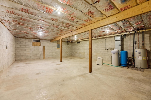 unfinished basement with water heater and concrete block wall