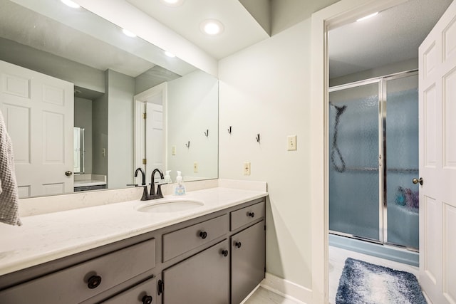 bathroom with baseboards, vanity, recessed lighting, and a shower stall