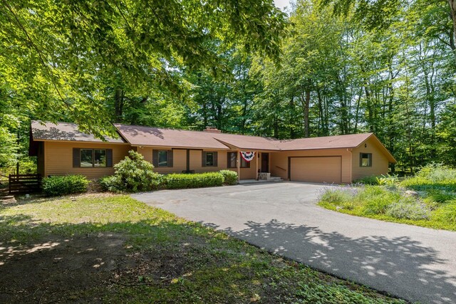 ranch-style home featuring driveway and a garage