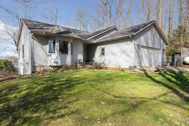 ranch-style home with an attached garage and a front yard