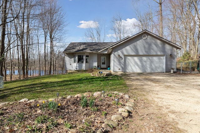 single story home featuring a garage, a front yard, driveway, and fence