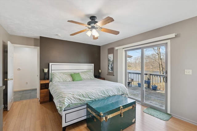 bedroom with hardwood / wood-style flooring, access to exterior, baseboards, and ceiling fan