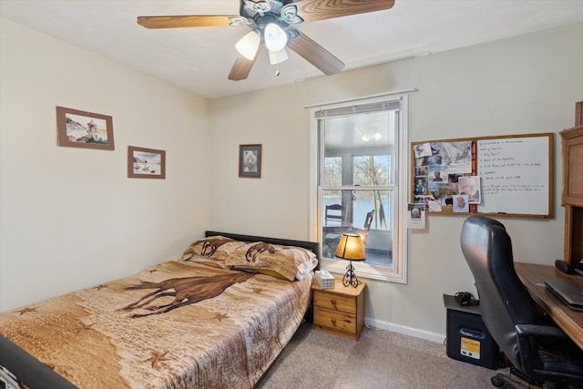 bedroom featuring ceiling fan, light colored carpet, and baseboards