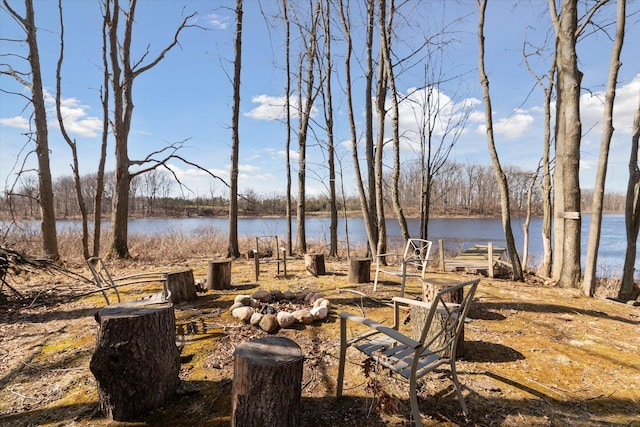 view of yard featuring a fire pit and a water view