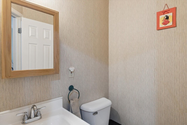 half bath with toilet and a sink