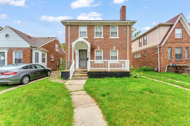 5767 Berkshire St, Detroit, MI 48224 - multi unit property featuring a chimney, brick siding, and a front lawn
