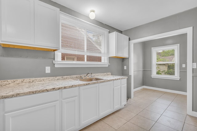 5767 Berkshire St, Detroit, MI 48224 - kitchen featuring a sink, white cabinets, light tile patterned floors, baseboards, and light stone counters