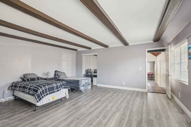 27423 W 12 Mile Rd, Farmington Hills, MI 48334 - bedroom with baseboards, light wood-type flooring, and beamed ceiling