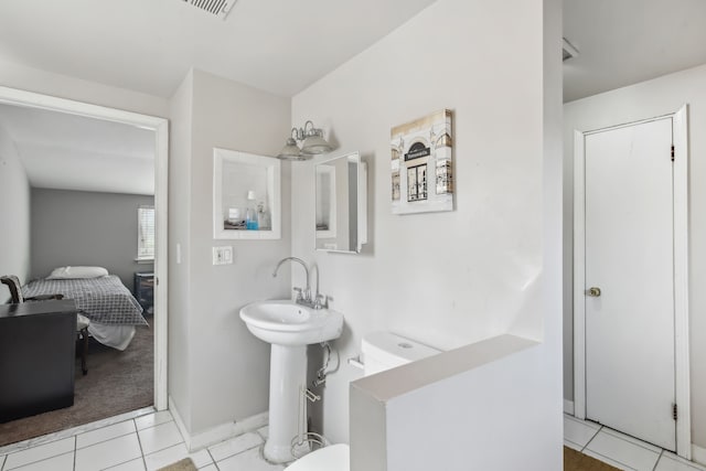 27423 W 12 Mile Rd, Farmington Hills, MI 48334 - ensuite bathroom with baseboards, a sink, toilet, ensuite bath, and tile patterned flooring