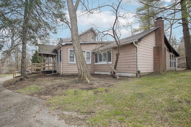 27423 W 12 Mile Rd, Farmington Hills, MI 48334 - view of property exterior featuring a yard, a shingled roof, a deck, and a chimney