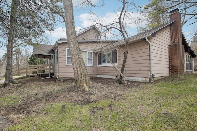 27423 W 12 Mile Rd, Farmington Hills, MI 48334 - view of side of home featuring a chimney, a shingled roof, and a lawn
