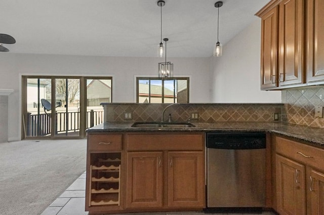29709 Francesca Ln, Chesterfield, MI 48047 - kitchen with a peninsula, stainless steel dishwasher, a sink, plenty of natural light, and brown cabinets