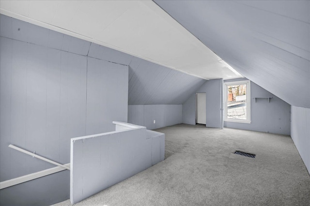 bonus room with lofted ceiling, visible vents, and carpet