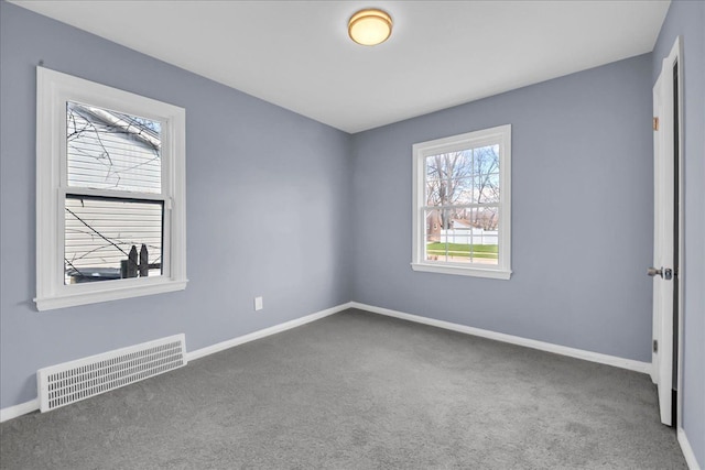 unfurnished bedroom with baseboards, visible vents, and carpet