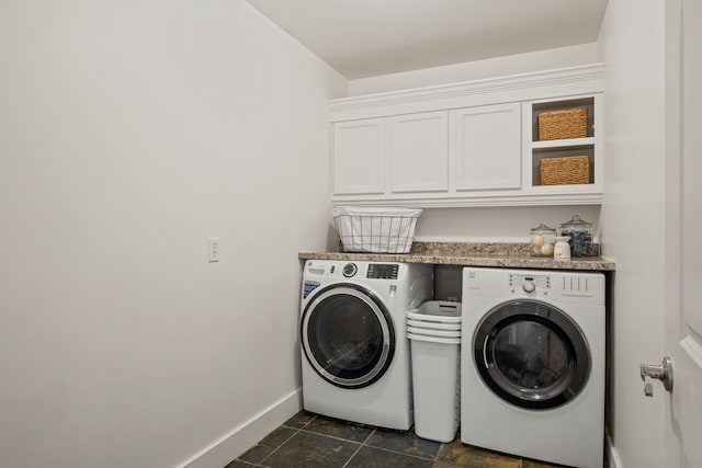 clothes washing area featuring cabinet space, baseboards, and separate washer and dryer