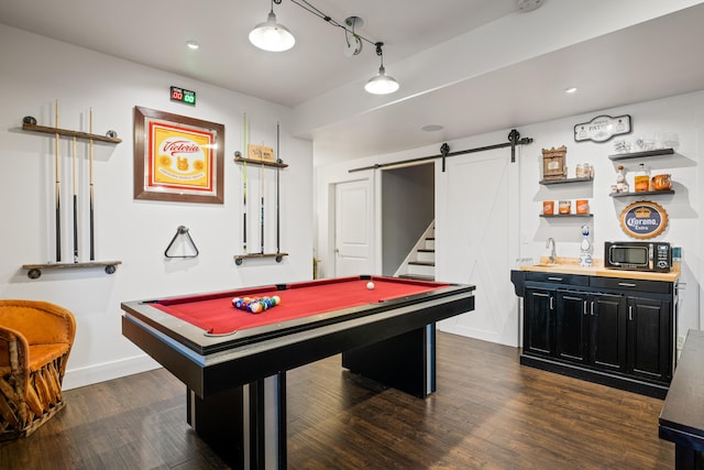 game room with dark wood-type flooring, a barn door, baseboards, and billiards