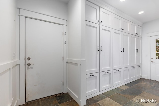 mudroom with recessed lighting and stone tile floors
