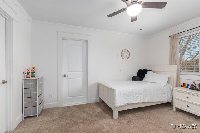 bedroom featuring ornamental molding, baseboards, a ceiling fan, and carpet floors