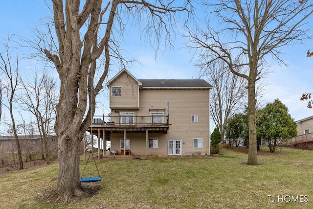 back of house featuring a deck and a lawn