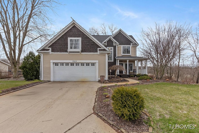 craftsman-style home featuring a front yard, a porch, and concrete driveway