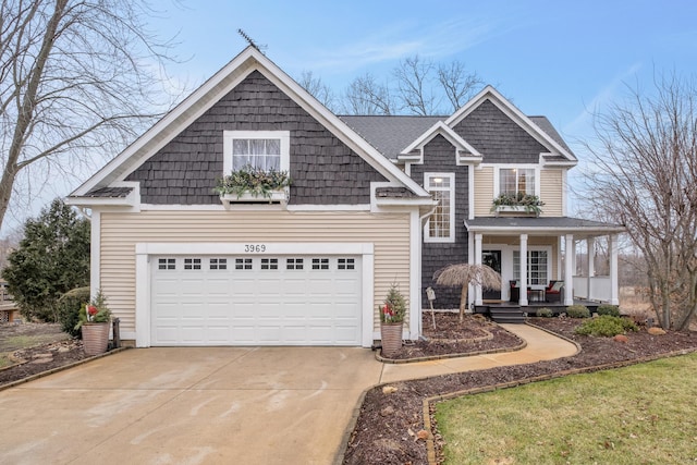 view of front of home featuring a porch and concrete driveway