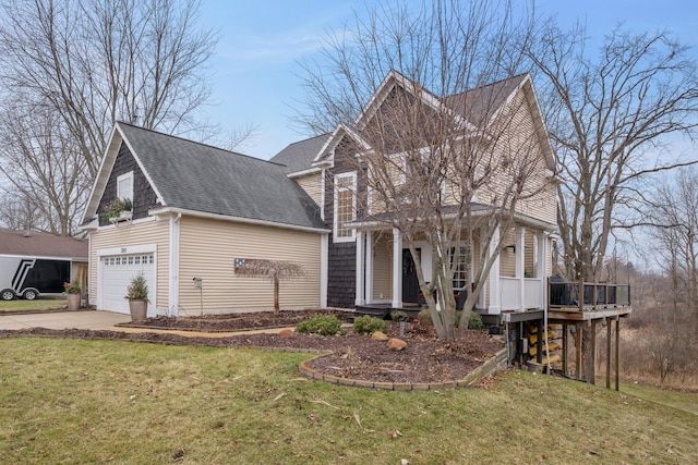 view of front of home featuring a wooden deck, a garage, a front lawn, a shingled roof, and driveway