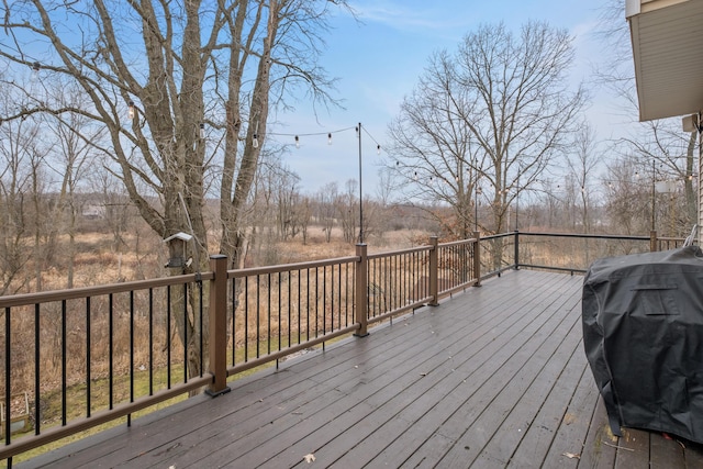 wooden terrace featuring a grill