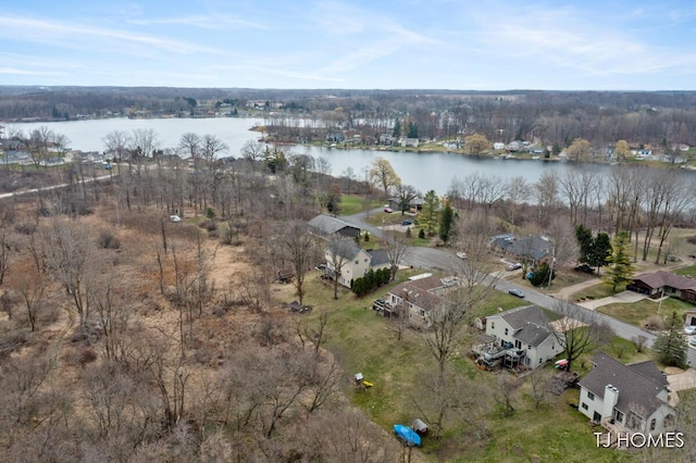 drone / aerial view with a water view and a residential view