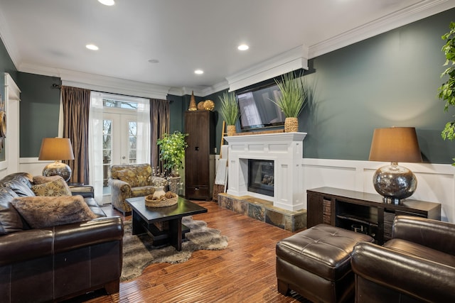 living room with crown molding, french doors, wainscoting, and wood finished floors