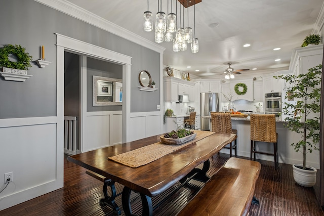 dining space featuring a ceiling fan, dark wood finished floors, crown molding, recessed lighting, and wainscoting