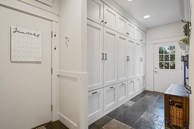 mudroom featuring baseboards, stone tile flooring, and recessed lighting