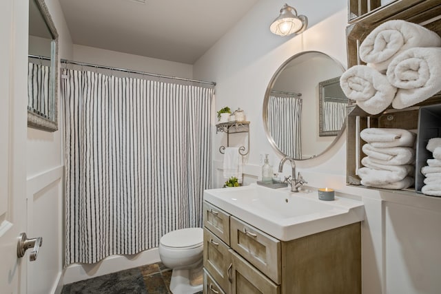 bathroom featuring toilet and vanity