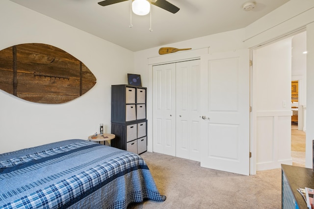 bedroom featuring a closet, ceiling fan, and light colored carpet